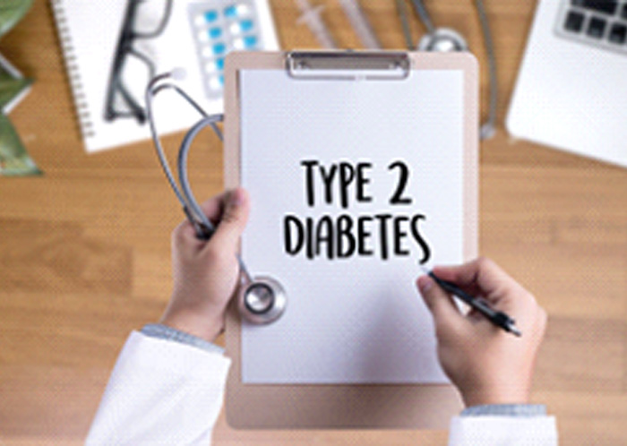 Holding clipboard that says “Type 2 Diabetes”