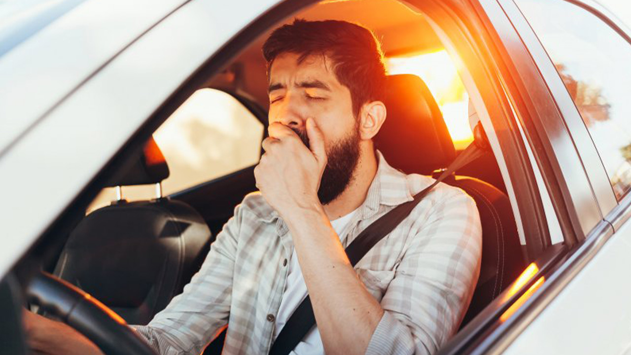 Man yawning while driving