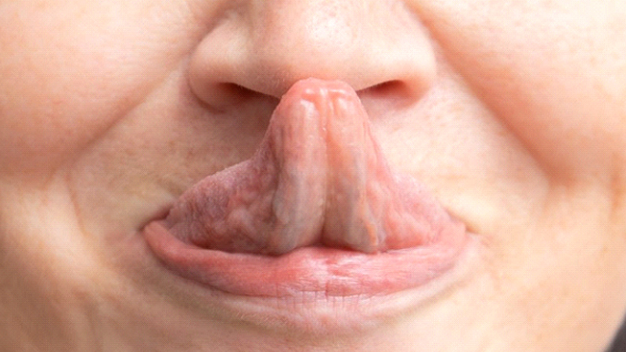 a person touching their nose with their tongue