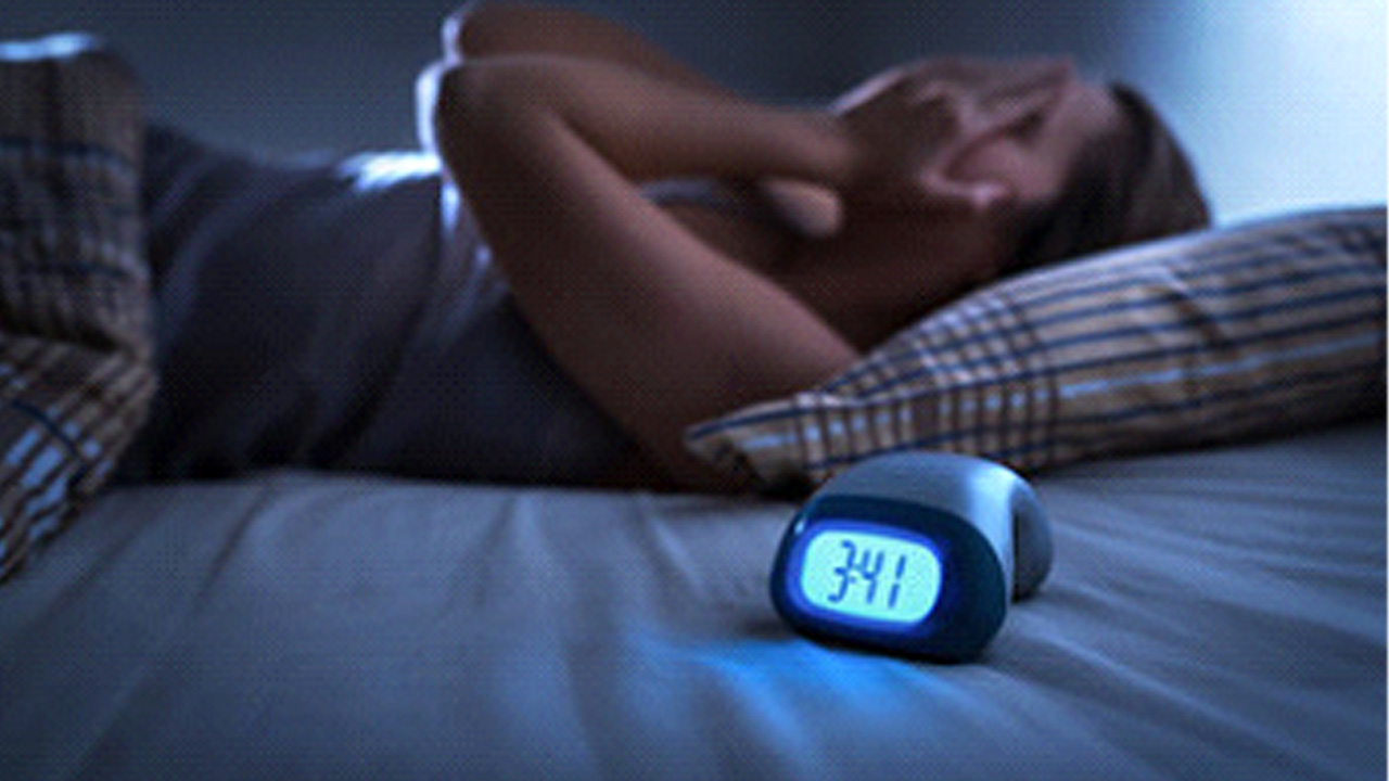Woman suffering through sleepless night. 