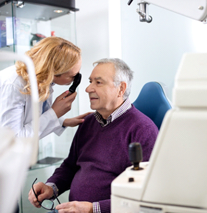 Senior man undergoing eye exam 